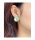 Groene oorclips met een geel strass steentje