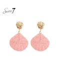 Roze oorhangers van raffia met een gehamerd oor stukje