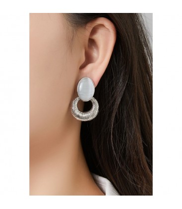 Goudkleurige oorclips met een wit cat eye steen