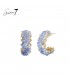 Oorbellen met blauwe kralen en goudkleurige details